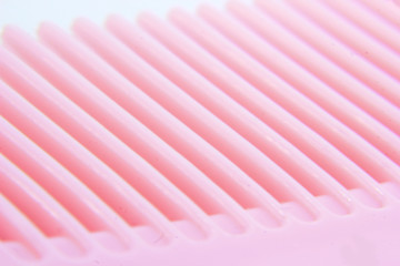 macro photo of pink hair comb