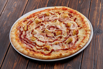 tasty pizza on the wooden background