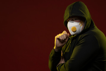 adult man with a beard in a hood and in a protective mask on his face with different emotions,...