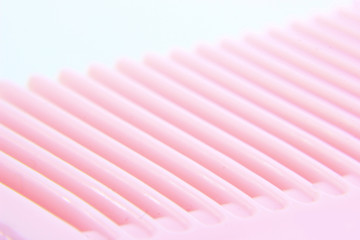 macro photo of pink hair comb