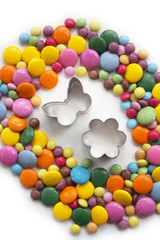 Colorful chocolate candies also called smarties in shape of a Easter egg with decoration isolated on white background. Easter background