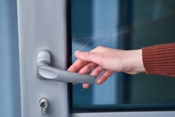Person opens the door. Hand on door handle