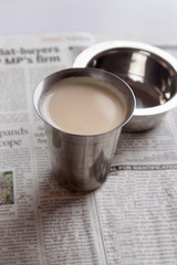 Glass of chai tea with small bowl
