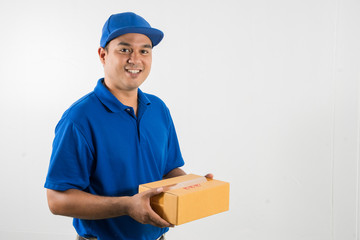 Blue Delivery handsome asian man holding parcel cardboard box on isolated white background.