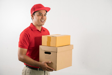 Red Delivery handsome asian man holding parcel cardboard box on isolated white background.