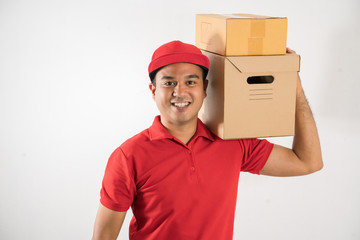 Red Delivery handsome asian man holding parcel cardboard box on isolated white background.