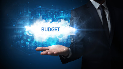 Hand of Businessman holding BUDGET inscription, successful business concept