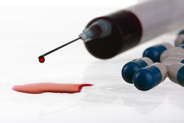 Macro view of drop of blood from syringe