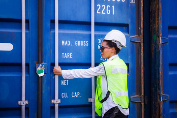 Female engineer checking containers box from cargo, Logistic concept