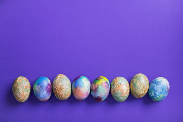 Easter eggs on a trend violet color background.