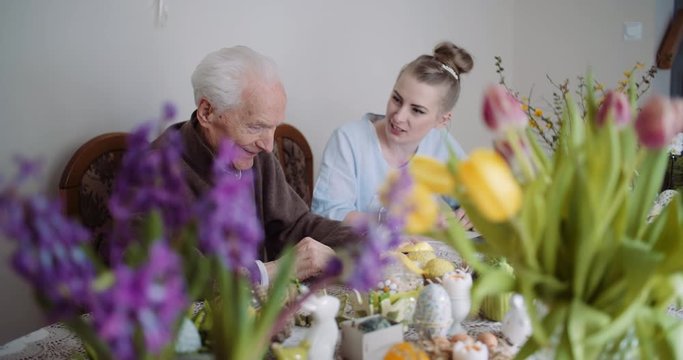 Happy Easter - Senior Man and Young Woman Conversating during Easter Holidays