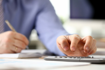 Accountant Manager Analyzing Investment Chart. Calculating Finance Budget Tax Report. Man Accounting Financial Business Data Using Calculator. Secretary Writing Note on Desk Working at Office