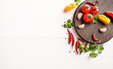 Vegetables on wooden board on white wooden background