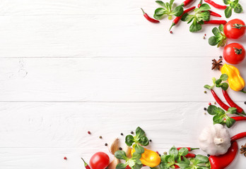 Frame of vegetables on white wooden background