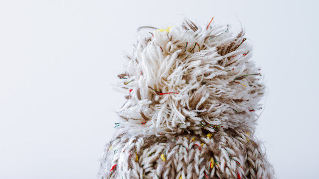 Pompon of knitted winter hat.