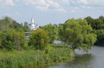 Fototapeta na wymiar Summer landscape with a view of the Kamenka river and the Church of St. Nicholas. Suzdal, Vladimir region. Golden ring of Russia