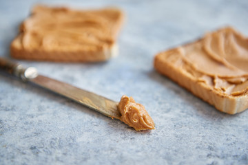 Two tasty peanut butter toasts placed on stone table