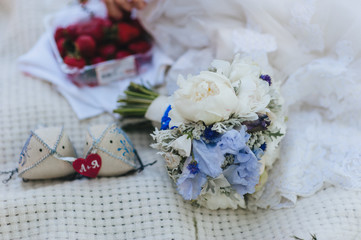 Wedding bouquet of peonies and gladioli close-up and a small pillow with a heart. Photography, concept.