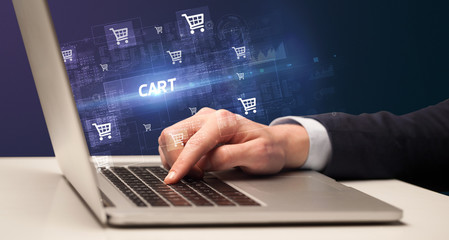 Fototapeta na wymiar Businessman working on laptop with CART inscription, online shopping concept