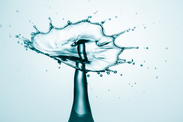 Water splash crown. Drop collision on blue background