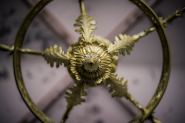 Middle of chandelier in a random church. Metal chandelier with golden paint.
