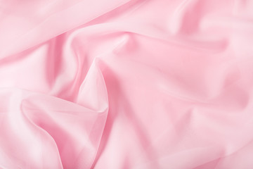 Tender pink silk draped fabric background