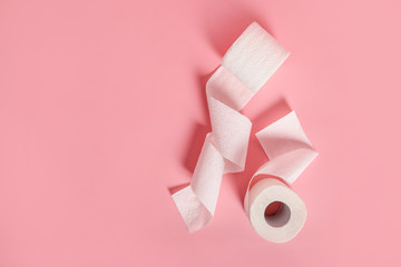 Toilet paper rolls on pink background
