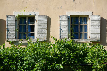 Fototapeta na wymiar Windows with wooden shutters
