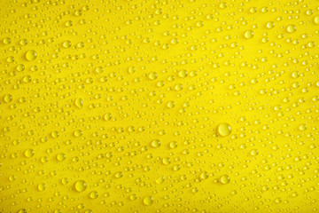 Water drops on yellow background