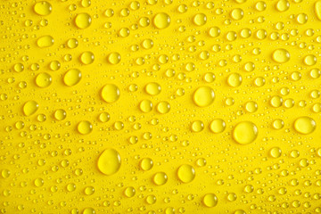 Water drops on yellow background