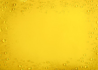 Frame of water drops on yellow background