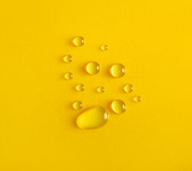 Fototapeta na wymiar Water drops on yellow background