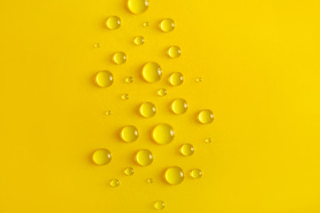 Water drops on yellow background