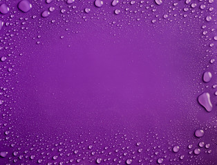 Frame of water drops on purple background