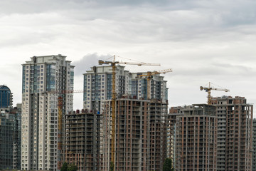 Buildings under construction. Lifting cranes