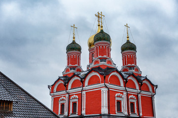 Fototapeta na wymiar Beautiful red Christian church in the center of Moscow on a gllomy sky background. Close-up.