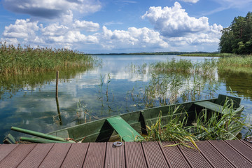 Boat on the Wigry Lake in Wigry National Park, view from a shore near Slupie and Gawrych Ruda villages, Poland