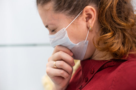 A Woman Coughing In Fits Is Sick With A Coronavirus Viral Infection That Spreads Coronavirus Without Covering Her Mouth And Nose. A Woman In A Medical Mask