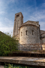 Fototapeta na wymiar Ancient parish Church of San Giorgio di Valpolicella or Ingannapoltron in Romanesque style (VII - XI century), with the bell tower and apse. Veneto, Verona province, Italy, Europe