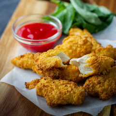Crispy chicken strips with ketchup