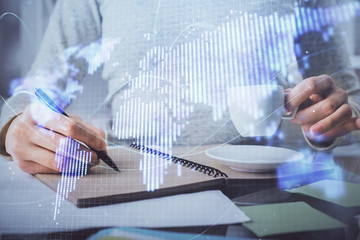 International business hologram over woman's hands taking notes background. Concept of success. Double exposure