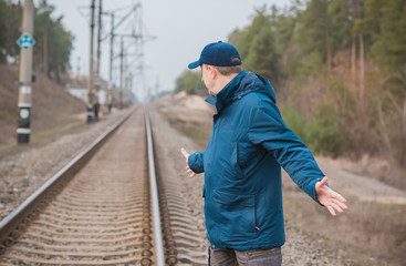 Obraz na płótnie Canvas Mature senior man on Railway, don't joke with rails 