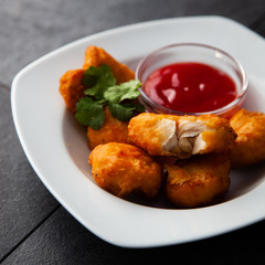 Crispy chicken nuggets with ketchup