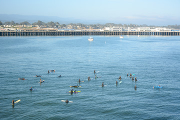 SANTA CRUZ, CALIFORNIA, USA - JULY 3, 2019: Surfers in the ocean near Lighthouse Field State Beach