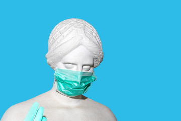 Head of sculpture of an antique woman in medical surgical mask and gloves as coronavirus prevention for hygiene corona virus protection.