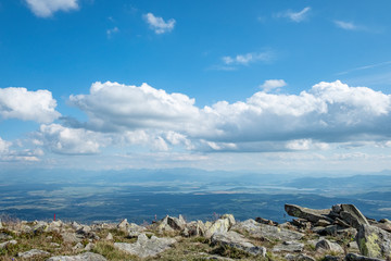 A panorama over a deep valley and the Tatra Mountains seen from the Babia Gora mountain (Sudety)