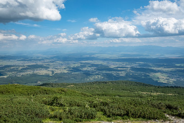 Obraz premium A panorama over a deep valley and the Tatra Mountains seen from the Babia Gora mountain (Sudety)