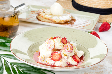 White ice cream with berry strawberries and syrup