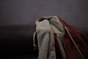 Isolated sweater with fur and with hood on the sofa (Pesaro, Italy, Europe)