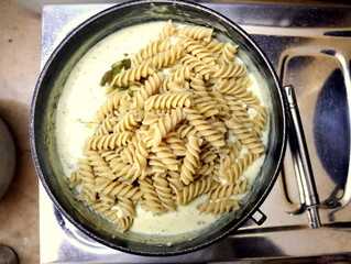 A closeup of a fresh delicious fusilli pasta in white sauce